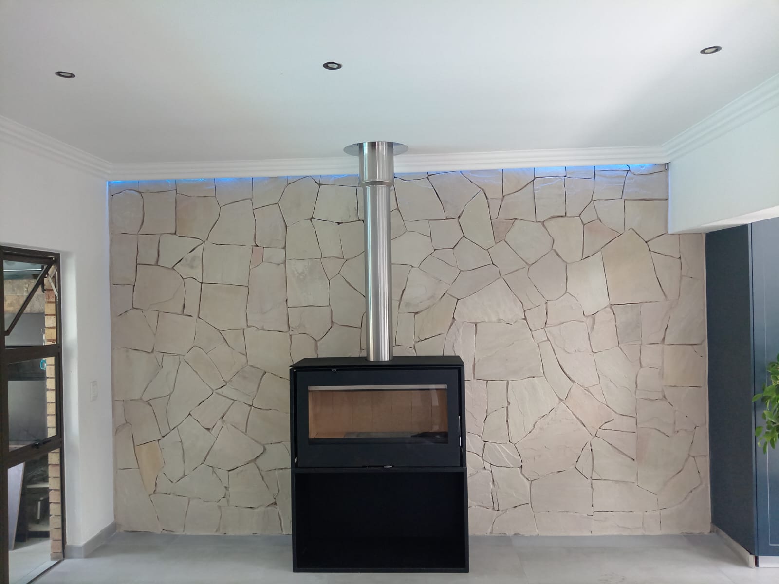 Freestanding stove on stone wall