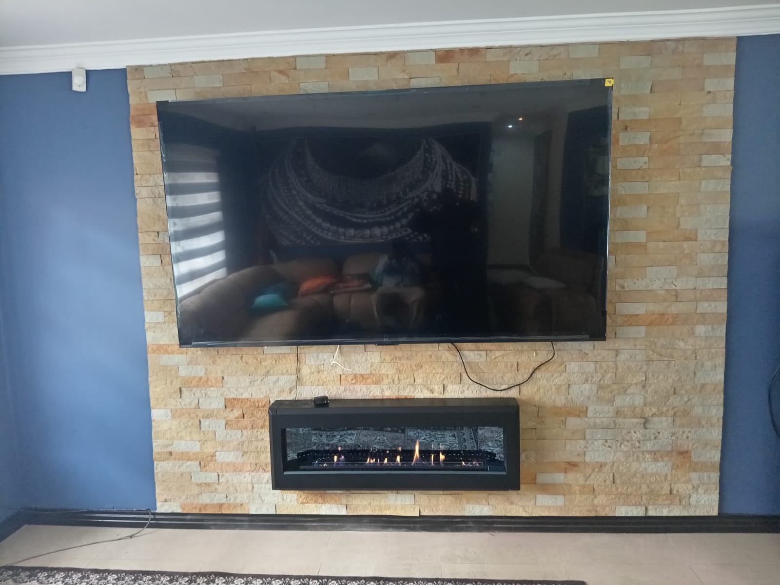 Stone-clad TV & fireplace wall
